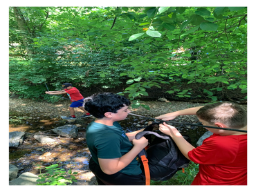 Kids outdoor adventure by stream